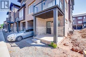 Hamilton (Parkview) townhouse for rent - A grey car is parked in front of a two-story building.