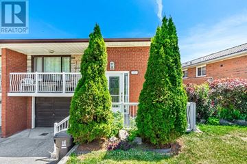 Toronto (Black Creek) apartment for rent - A house with a red brick facade and a white balcony is for sale.