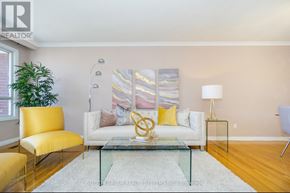 Toronto (Black Creek) apartment for rent - A living room with a yellow chair, a white sofa, and a glass coffee table.