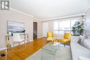 Toronto (Black Creek) apartment for rent - A living room with a glass coffee table and yellow chairs.