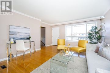 Toronto (Black Creek) apartment for rent - A living room with a glass coffee table and yellow chairs.