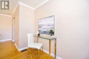 Toronto (Black Creek) apartment for rent - A room with a white chair and a painting on the wall.