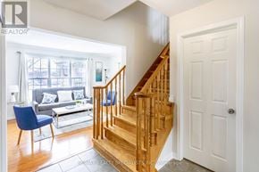 Milton (Cl Clarke) apartment for rent - A living room with a blue chair and a wooden staircase.