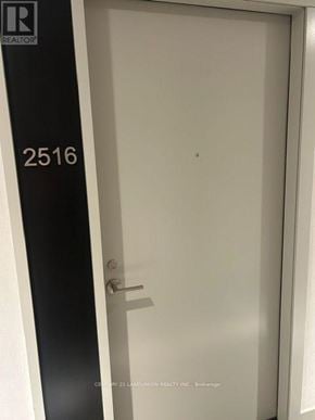 Toronto (Waterfront Communities) condo for rent - A white door with a black frame and a silver handle.
