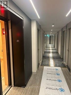 Toronto (Waterfront Communities) condo for rent - A hallway with a blue and white carpet with the word "CENTER" on it.