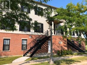 Niagara-On-The-Lake (Town) multi-family for rent - A brick building with a black staircase in front.