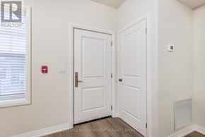 Niagara-On-The-Lake (Town) multi-family for rent - A white door with a red fire alarm on the wall.