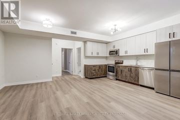 Niagara-On-The-Lake (Town) multi-family for rent - A spacious kitchen with white cabinets and a refrigerator.