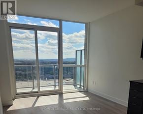 Milton (Om Old Milton) condo for rent - A room with a large window overlooking a cityscape.