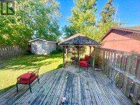 Welland (Lincoln/Crowland) duplex for rent - A wooden deck with a gazebo and red chairs.
