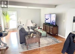 Welland (Lincoln/Crowland) duplex for rent - A living room with a grey couch, a wooden coffee table, and a flat screen TV.