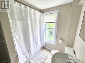 Welland (Lincoln/Crowland) duplex for rent - A white shower curtain is hanging in a bathroom.