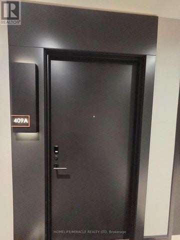 Milton (Tm Timberlea) condo for rent - A black door with a glass window and a sign on the left side.