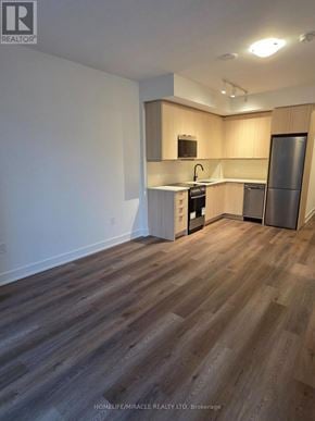 Milton (Tm Timberlea) condo for rent - A kitchen with wooden floors and white walls.