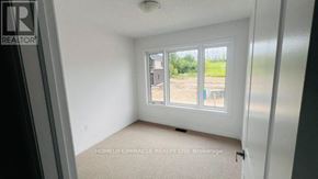 Woodstock (Woodstock - South) townhouse for rent - A room with a window showing a view of a construction site.