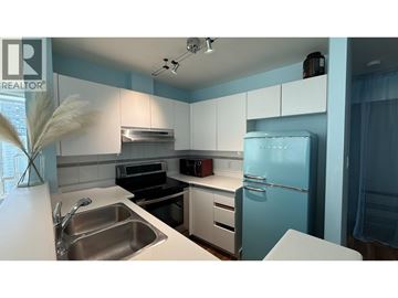 Vancouver apartment for rent - A living room with a grey sofa and a flat screen TV.