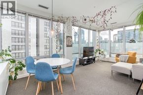 Vancouver apartment for rent - A living room with a grey carpet and a white table.