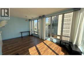 Vancouver apartment for rent - A living room with a grey sofa and a grey carpet.