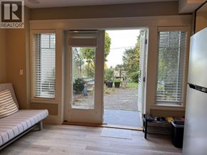 West Vancouver apartment for rent - A realtor's office with a view of a backyard through the sliding glass doors.