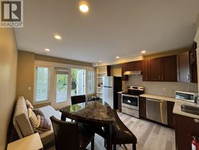 West Vancouver apartment for rent - A modern kitchen with a dining table and chairs.