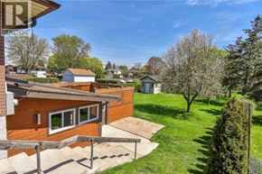 Cambridge apartment for rent - A house with a brown roof and a green lawn in front.