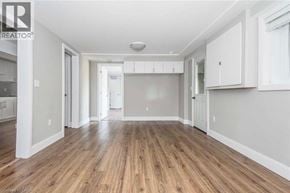 Cambridge apartment for rent - A spacious room with wooden flooring and white walls.