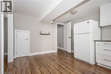 Cambridge apartment for rent - A white refrigerator is in a kitchen with wood floors and white walls.