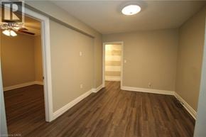 Hamilton apartment for rent - A room with wooden floors and white walls.