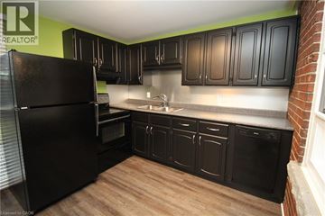 Hamilton apartment for rent - A kitchen with black cabinets and a black refrigerator.