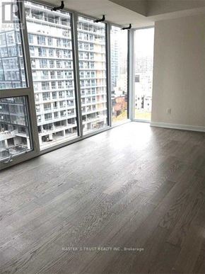 Toronto (Church-Yonge Corridor) condo for rent - A room with a view of a cityscape through large windows.
