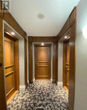 Toronto (Woburn) condo for rent - A hallway with wooden doors and a carpeted floor.