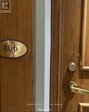 Toronto (Woburn) condo for rent - A brown door with a brass number plate reading 806.