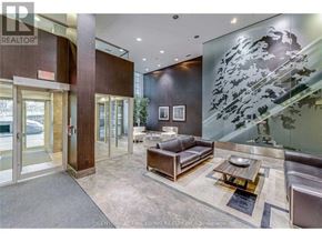 Toronto (Niagara) condo for rent - A modern living room with a glass wall and a wooden floor.