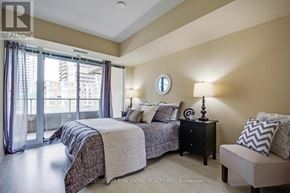 Toronto (Niagara) condo for rent - A bedroom with a large bed and a window with curtains.