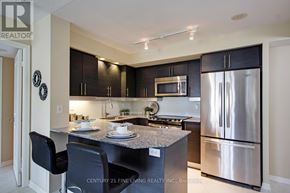 Toronto (Niagara) condo for rent - A kitchen with a black chair and a black counter top.