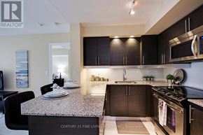 Toronto (Niagara) condo for rent - A kitchen with granite countertops and stainless steel appliances.