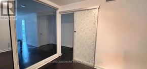 Toronto (Waterfront Communities) condo for rent - A room with a glass door and a white door with frosted glass.