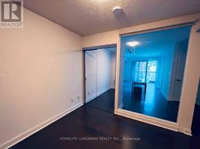 Toronto (Waterfront Communities) condo for rent - A room with a mirror showing a dining area.