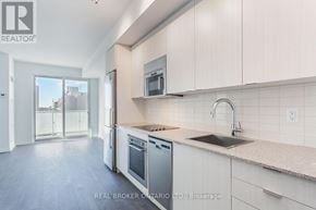 Toronto (Mount Pleasant West) condo for rent - A modern kitchen with white cabinets and stainless steel appliances.