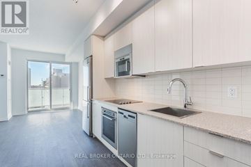 Toronto (Mount Pleasant West) condo for rent - A modern kitchen with white cabinets and stainless steel appliances.