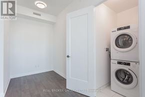 Toronto (Mount Pleasant West) condo for rent - A white door is in a room with a washer and dryer on the wall.