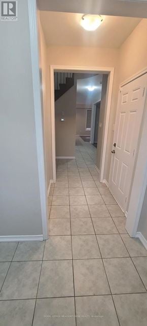 Brantford apartment for rent - A hallway with tiled floors and white walls.