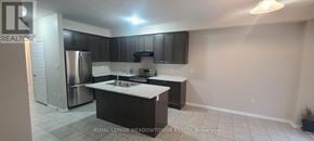 Brantford apartment for rent - A kitchen with black cabinets and a white countertop.