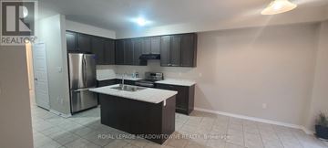 Brantford apartment for rent - A kitchen with black cabinets and a white countertop.