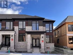 Pickering townhouse for rent - A modern two-story house with a black front door and windows.