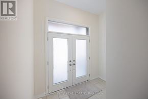 Pickering townhouse for rent - A white door with a glass panel is in a room with white walls.
