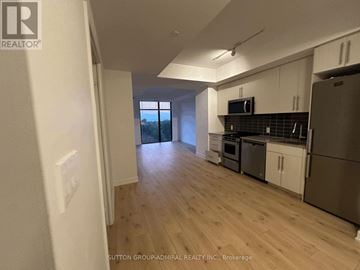 Toronto (Cliffcrest) condo for rent - A kitchen with white cabinets and a stainless steel refrigerator.