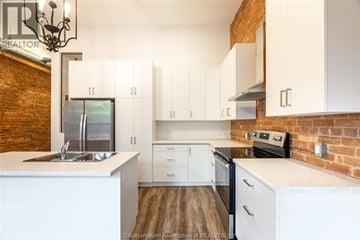 Chatham apartment for rent - A kitchen with white cabinets and a brick wall.