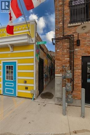 Chatham apartment for rent - A yellow and blue building with a Canadian flag on top.