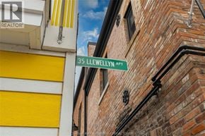 Chatham apartment for rent - A street sign for 35 Llewellyn Apt is mounted on a brick building.